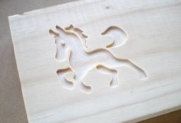 Horse cut into pine